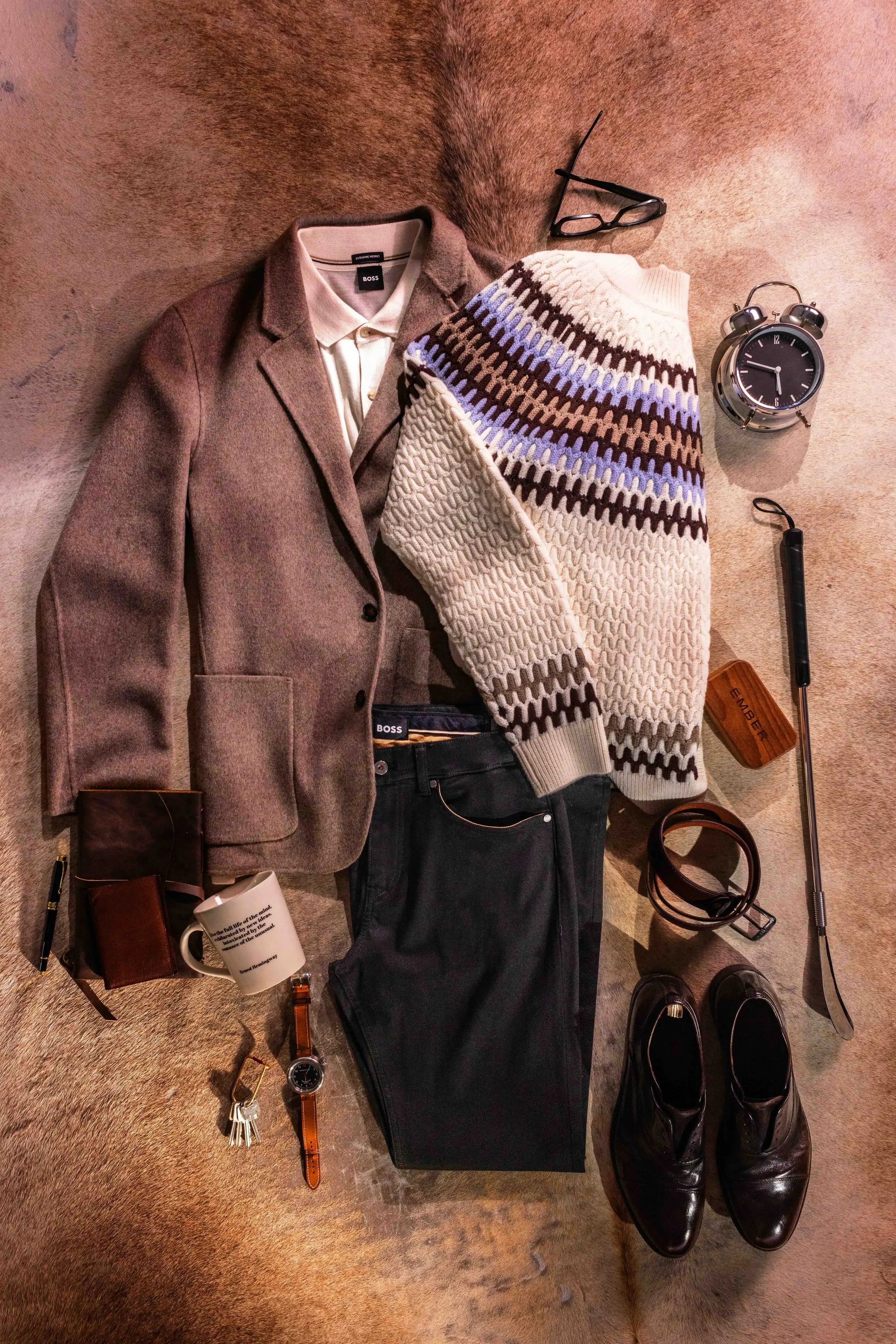 HANK wool blazer, knitwear and everyday accessories arranged on a table